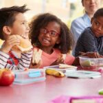 children eating lunch at a table