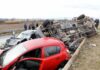 Overturned truck and damaged cars after highway crash