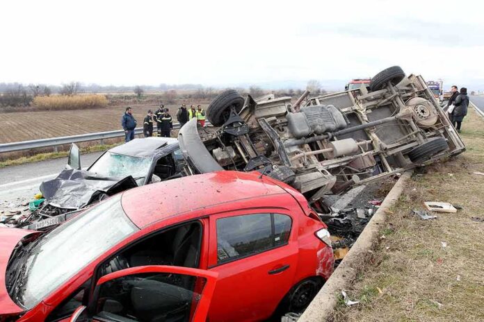 Overturned truck and damaged cars after highway crash