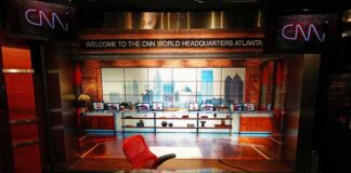 CNN studio set with empty anchor desk and red chair