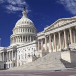 The U.S. Capitol building with its dome and columns under a blue sky