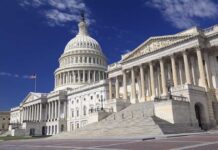 The U.S. Capitol building with its dome and columns under a blue sky
