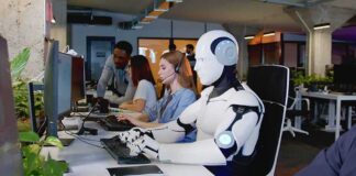 Robot and office workers at computers in a modern workspace