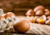 Brown eggs on rustic wooden table