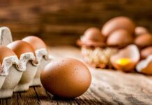 Brown eggs on rustic wooden table