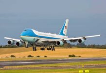 Airplane landing on runway with landing gear extended