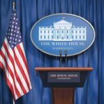 White House press briefing podium and US flag