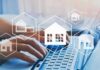 Hands typing on laptop with real estate house icons overlay