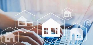 Hands typing on laptop with real estate house icons overlay