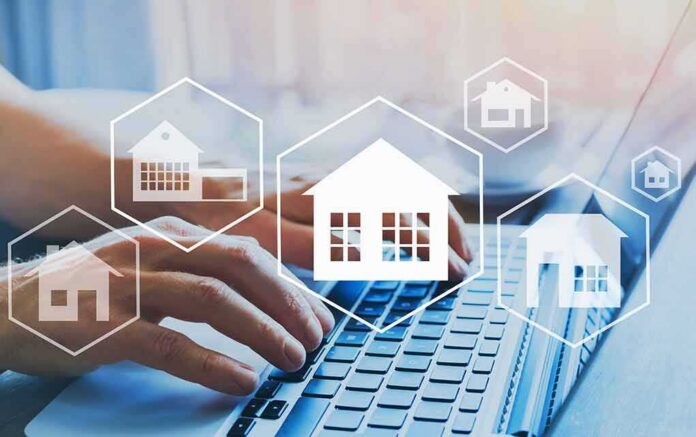 Hands typing on laptop with real estate house icons overlay