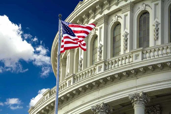 shutterstock_1243625368 American flag waving before a neoclassical government building