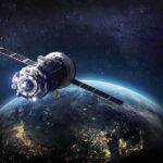 Satellite orbiting Earth over night side