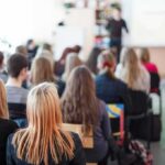 Students seated in a classroom listening to a presentation