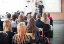 Students seated in a classroom listening to a presentation