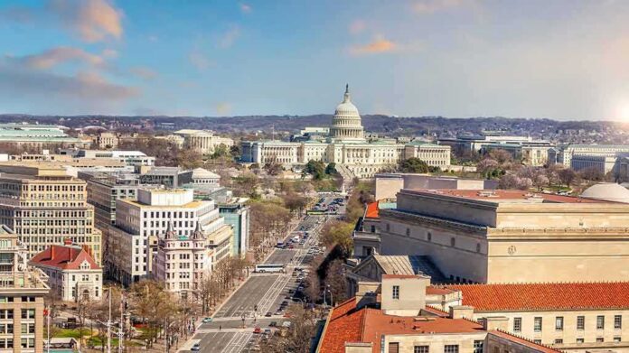United States Capitol building with cityscape and broad avenue