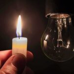 candle flame held near an unlit light bulb