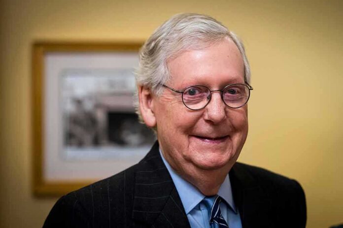 elderly man wearing glasses and a suit smiling