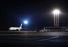 Airliner on a dimly lit airport tarmac at night