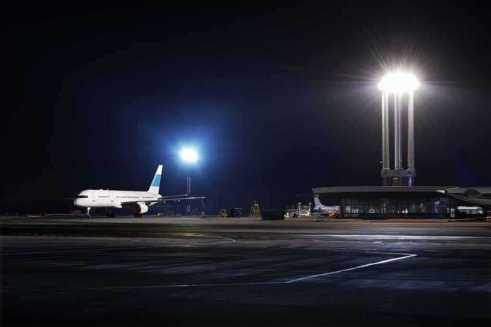 Airliner on a dimly lit airport tarmac at night