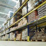 Interior view of a warehouse with stacked shelves of packaged goods