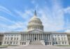 United States Capitol building with dome under a blue sky