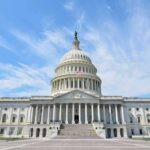 United States Capitol building with dome under a blue sky