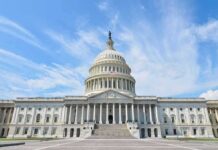 United States Capitol building with dome under a blue sky