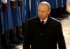 Vladimir Putin walking past a guard of honor