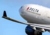 Delta Air Lines commercial jet ascending with wing and engine visible