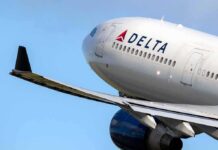 Delta Air Lines commercial jet ascending with wing and engine visible
