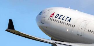 Delta Air Lines commercial jet ascending with wing and engine visible