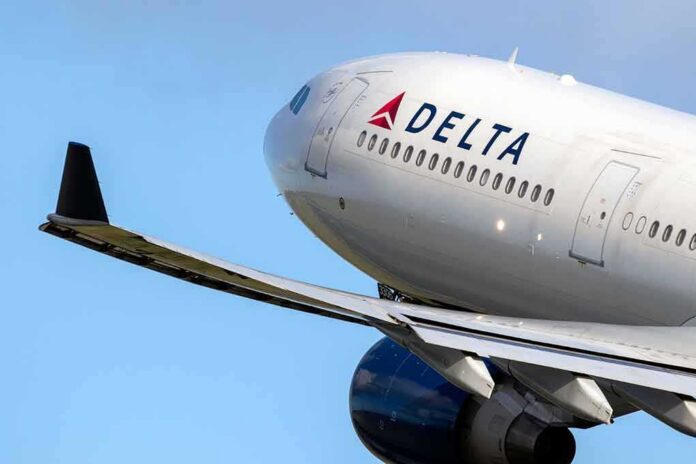 shutterstock_1474630895 Delta Air Lines commercial jet ascending with wing and engine visible