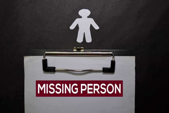 clipboard with missing person notice and paper cutout figure