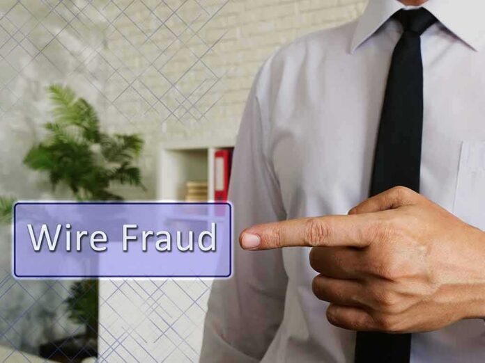 Businessperson pointing at wire fraud text overlay