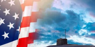 Submarine at sea beside a partial American flag