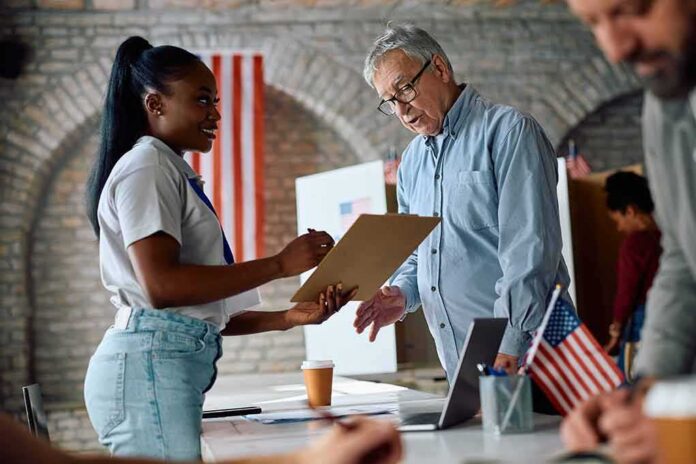 Voter signs a form at a polling station desk